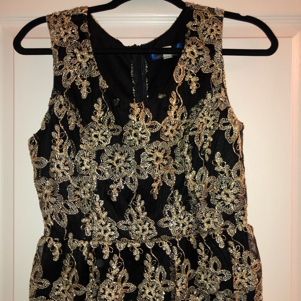 Black and gold peplum top